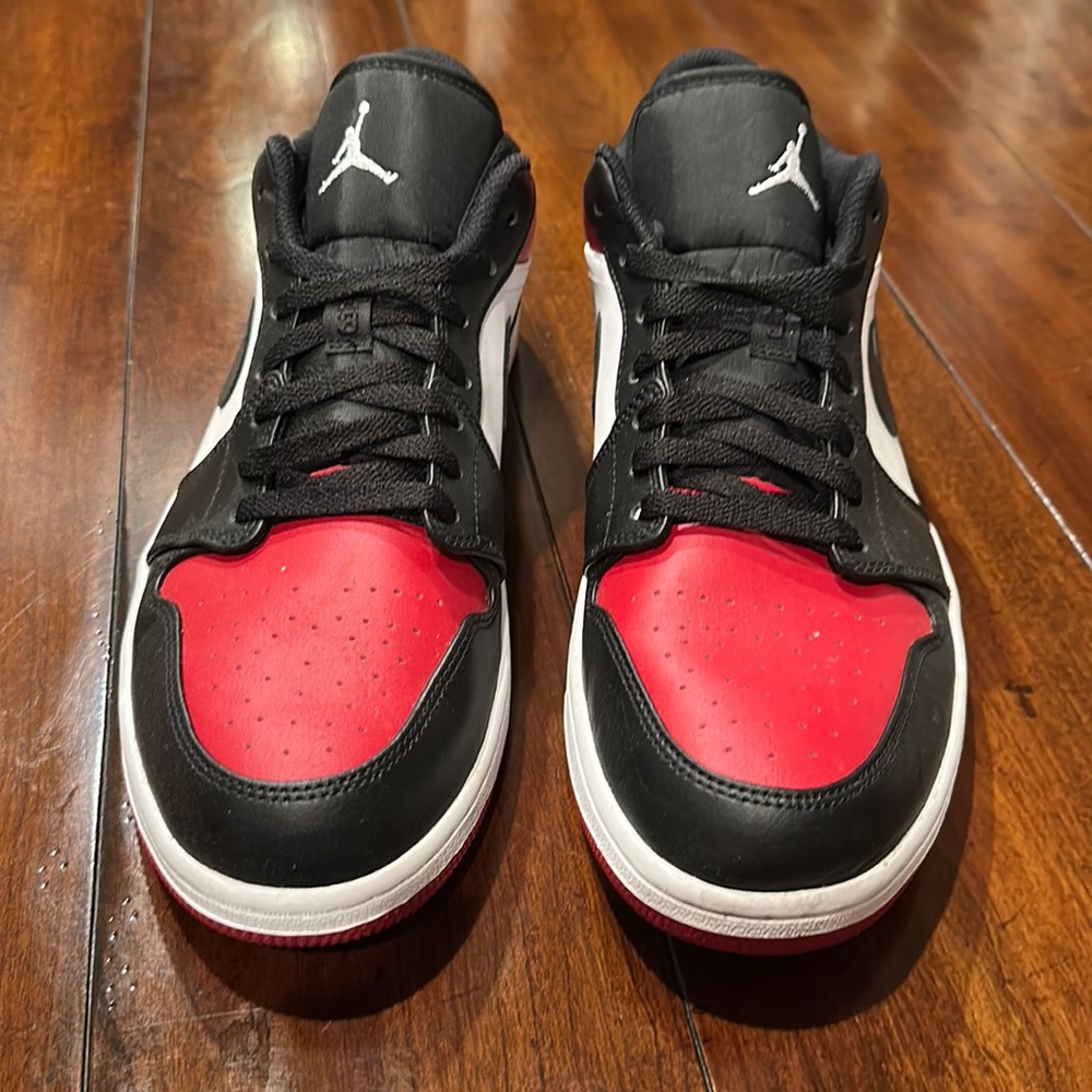 worn once, these like-new Jordan 1 lows are in the “bred” color way.  No box